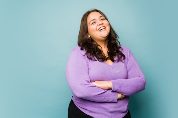 An overweight woman laughing