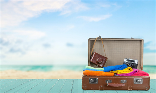 Retro suitcase with travel objects on sea background is tijuana safe