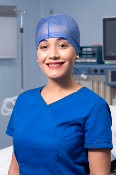 Surgeon wearing blue scrubs in the or